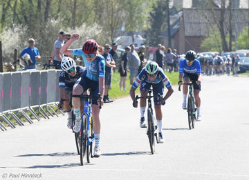 Abby McLain of Simpson Nouvelles women's cycling team taking 4th in a sprint finish at the Ottergem GP in April 2025. The race was won by Dutch rider Quinty van de Guchte, seen here celebrting.