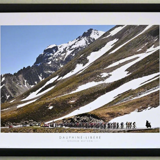 Poster. 2009 Critérium du Dauphiné. The Peloton climb the Col Du Galibier. Although June, snow still covers large parts of the mountain.