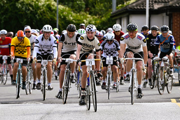 A boy leading a group of riders at the 2024 Simpson Retro in full retro Peugeot team kit.