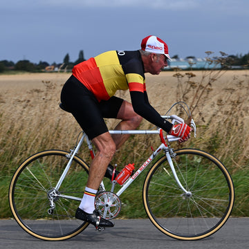 A man riding in a Belgium national champions retro jersey in the 2024 Simpson Retro cycling event on an Eddy Merckx bike.