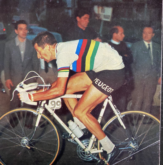 Tom Simpson on his bike wearing the World Championships Rainbow Jersey