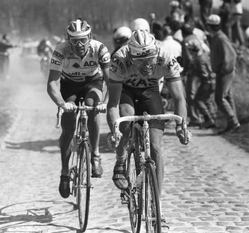 Thomas Wegmuller of Switzerland (leading) and Dirk De Mol riding over the cobbles