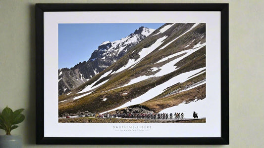 Poster. 2009 Critérium du Dauphiné. The Peloton climb the Col Du Galibier. Although June, snow still covers large parts of the mountain.