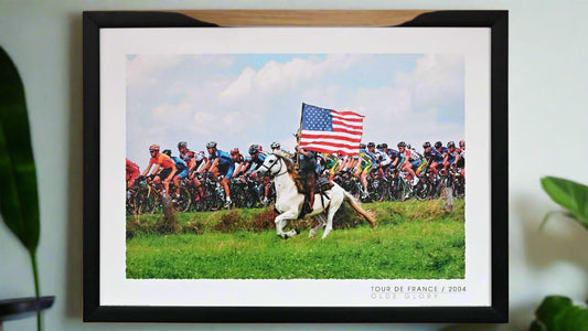 A belgian horseman greets the Tour de France - riding alongside the peloton carrying the star striped banner of the USA.